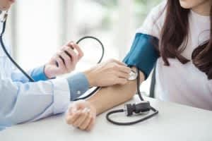 woman getting her blood pressure checked